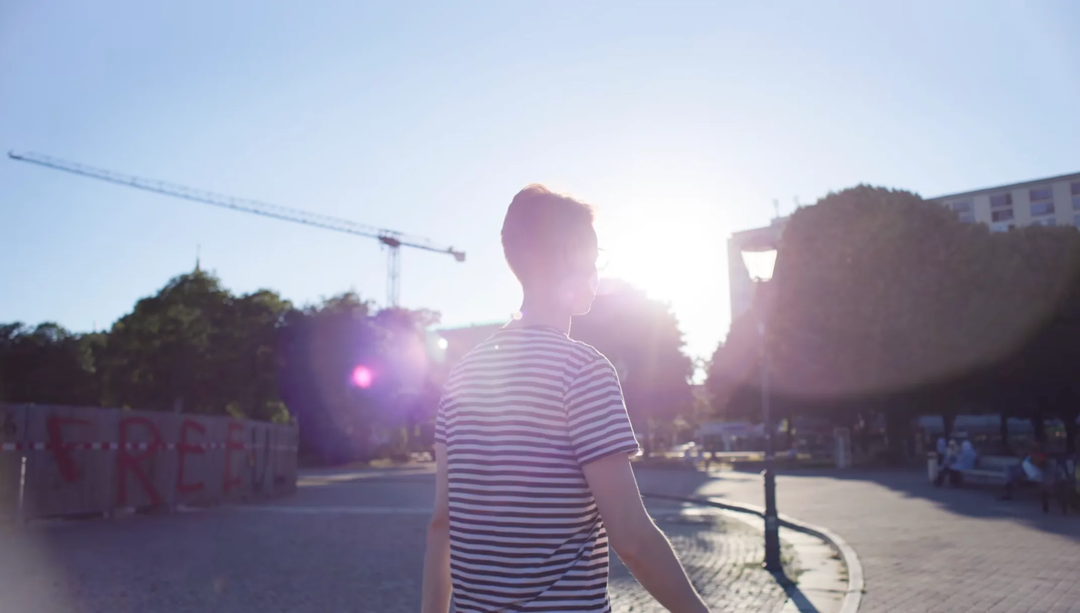 A student walking into the evening sun